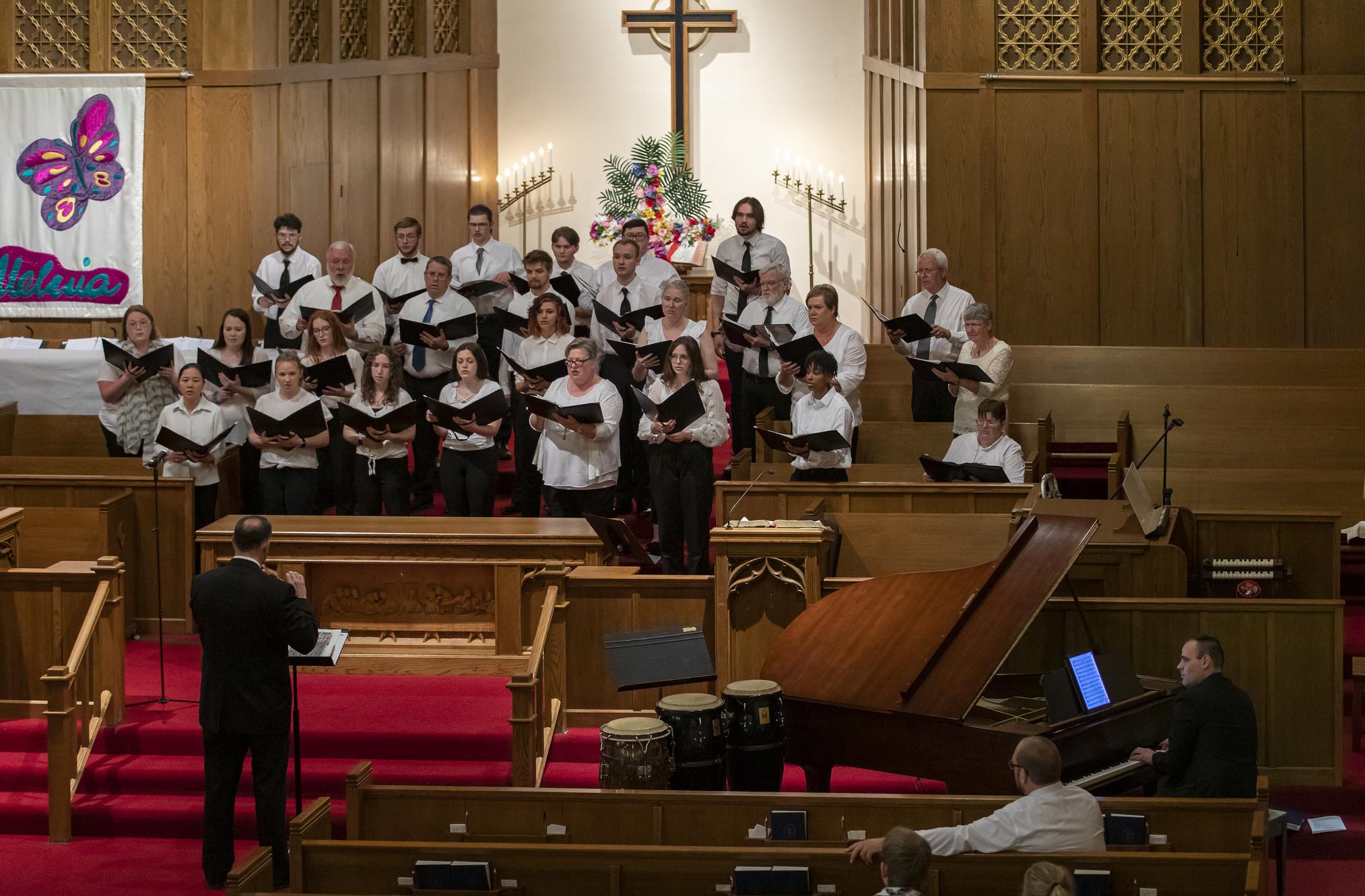 a group of people singing in a church